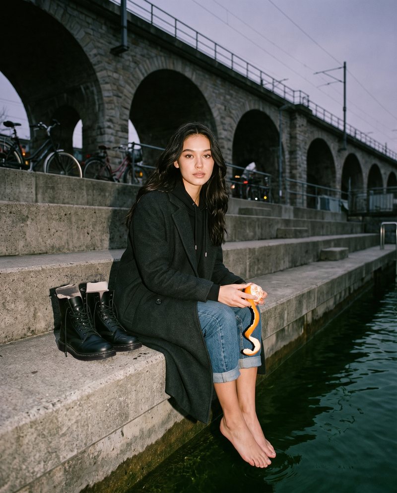 Nova Rai barefoot on the steps of an empty river bath in late October